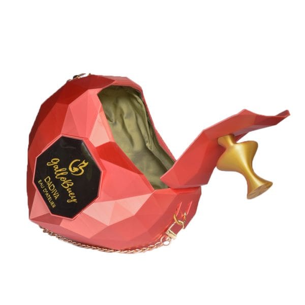 Juego visual de GalloBuey en la pasarela: El bolso Dádiva Rojo impreso en 3D simulando un perfume, accesorio de lujo para Juan Duyos